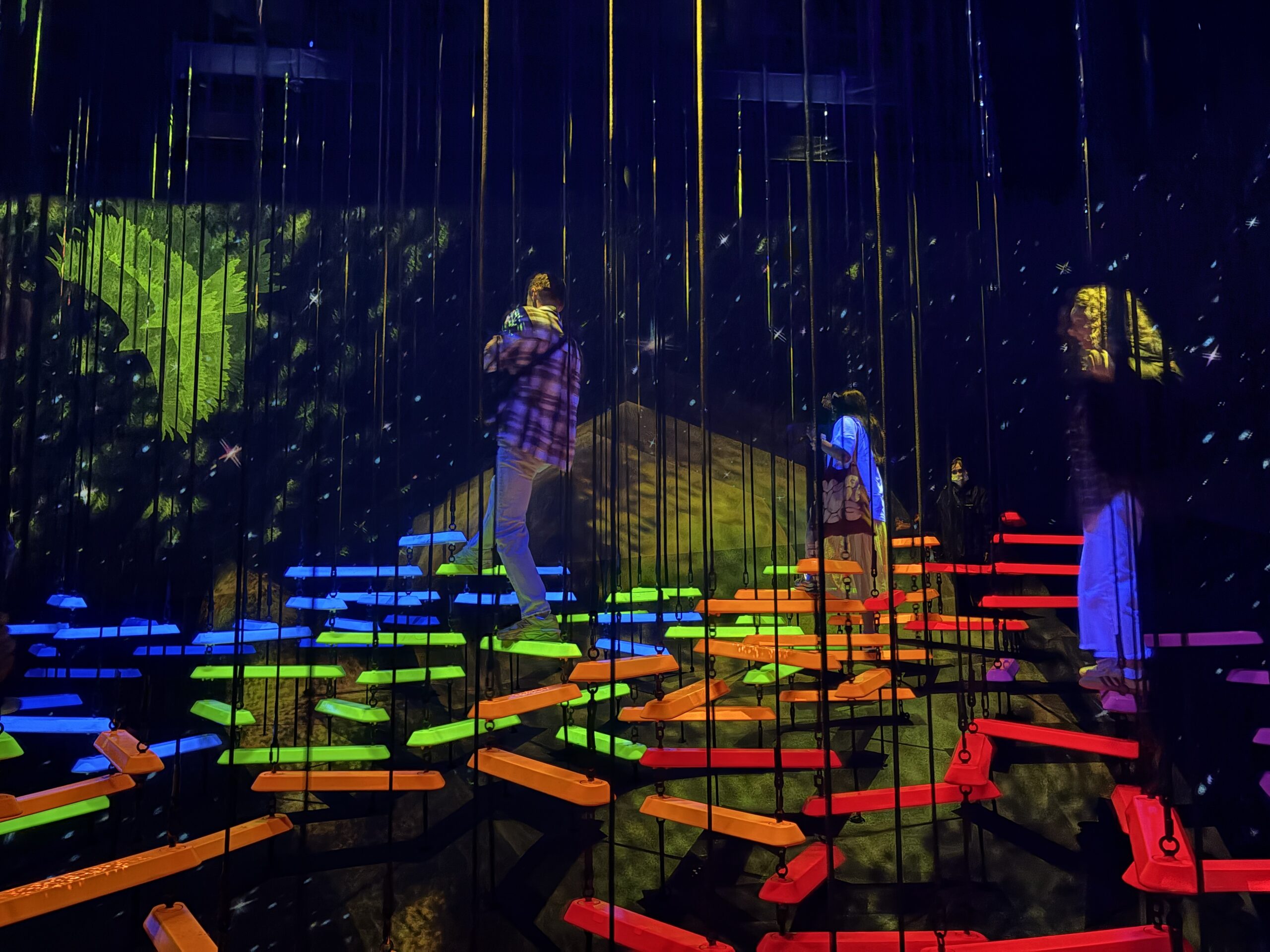 Colorful suspended climbing installation in Athletics Forest at teamLab Planets Tokyo